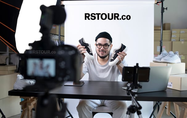 a man sitting at a table with a camera and a camera