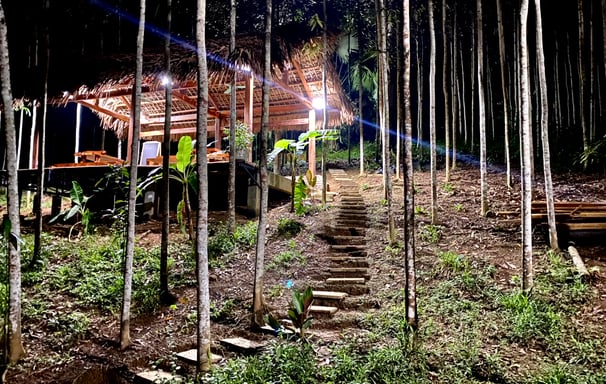 a house with a staircase leading up to a small cabin