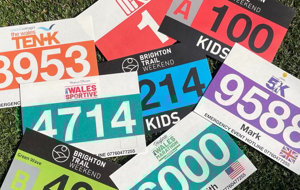 a photo of a pile of multi-colore race bibs