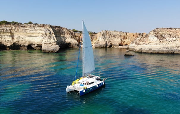 a sailboat in the water with a sailboat in the background