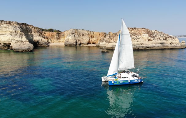 a sailboat in the water with a sailboat in the background