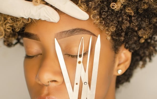 a woman with a pair of scissors and a pair of scissors