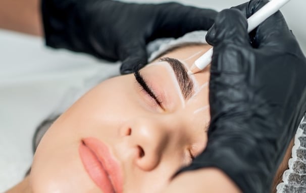 a woman with a black glove on her forehead