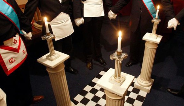 a group of men in formal attire standing in a room