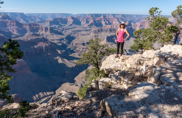 Janet standing on a cliff overlooking the Grand canyon