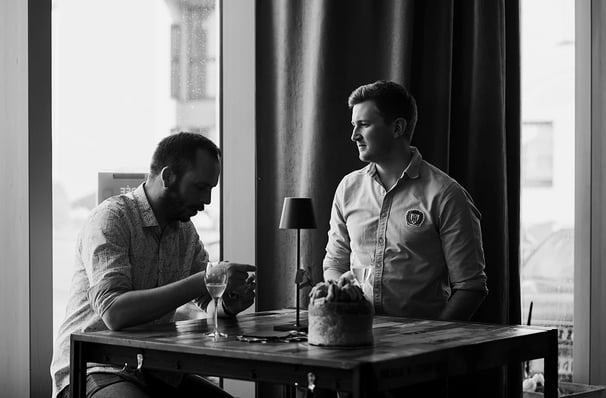 Moment de discussion en noir et blanc lors d’un afterwork au Den Dem Café à Luxembourg.