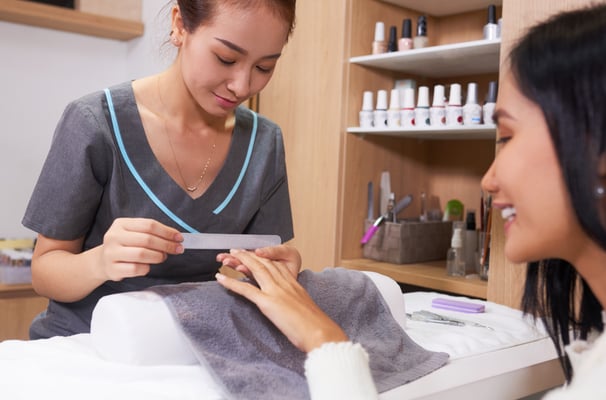 A customer is enjoying a nail treatment session at a professional nail salon