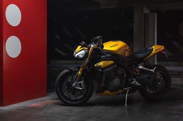 a yellow motorcycle parked in a parking lot