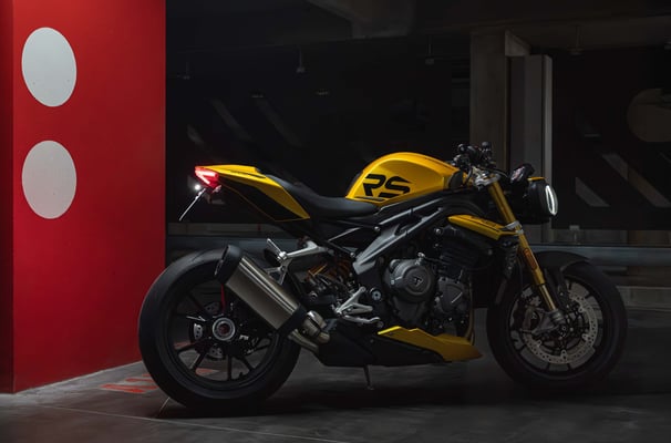 a yellow motorcycle parked in a parking lot