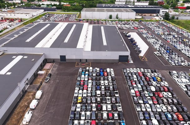 a parking lot with cars parked in front of a building