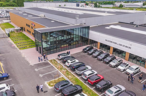 a parking lot with cars parked in front of a building