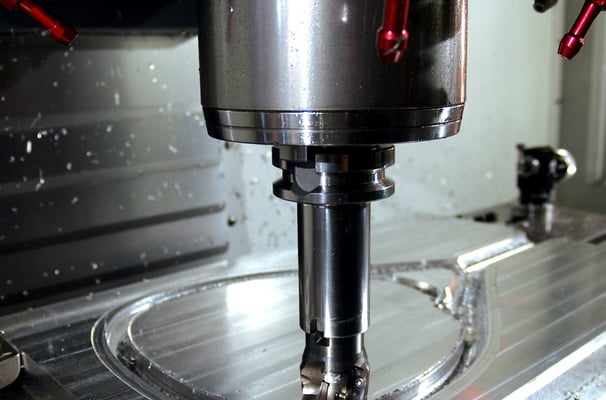 a CNC machine is making a hole in the center of a machine