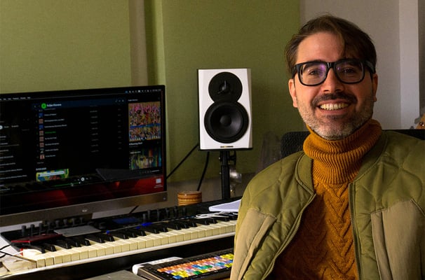 a man in a jacket and glasses is smiling