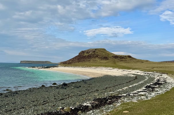 Black beach showing the clear sea