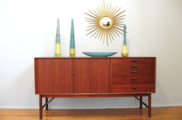 a dresser with vases and vases on it