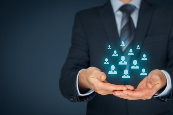 Target audience icons floating above businessperson’s hands
