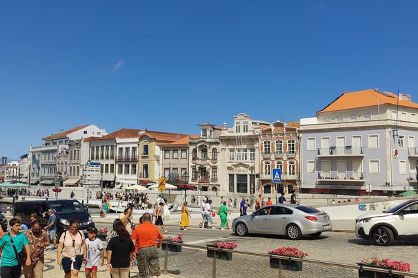 a group of people standing around a city street