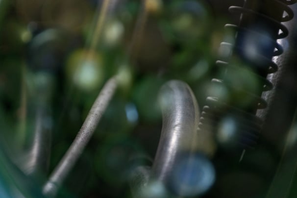 Glass pebbles with a water house in the reflection.