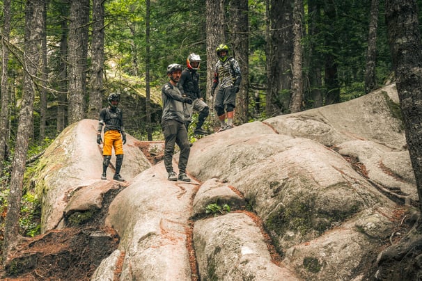 coach teaching a group of people riding on a mountain bike