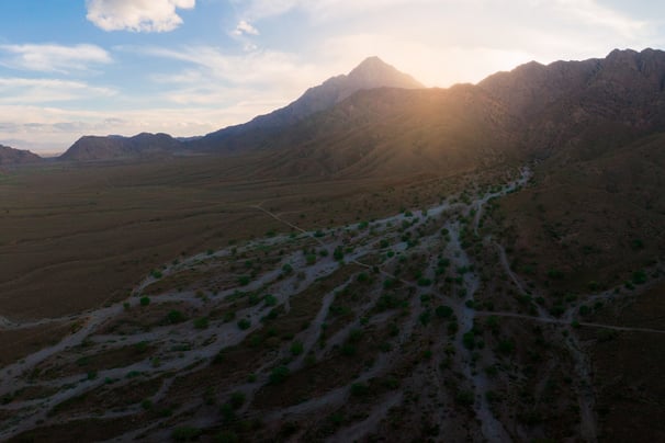 a mountain scene with a view of a valley