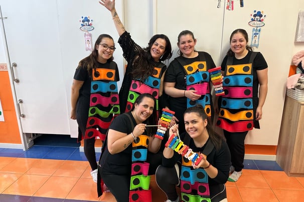 a group of people in colorful costumes posing for a picture