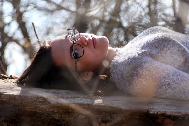 Portrait of woman laying on side facing camera