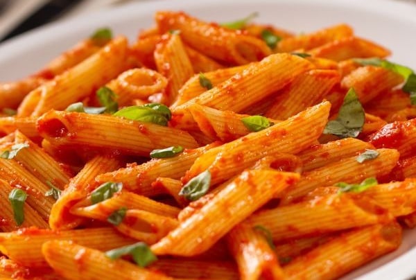 a plate of pasta with a red sauce