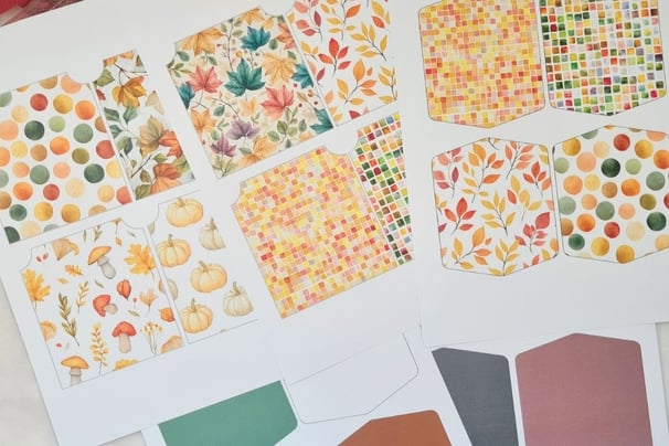 Cut apart autumn-themed craft paper featuring patterns of colorful fall season