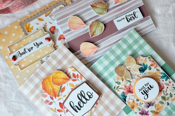 A collection of four handmade greeting cards with autumn themes. The colors are warm and inviting.