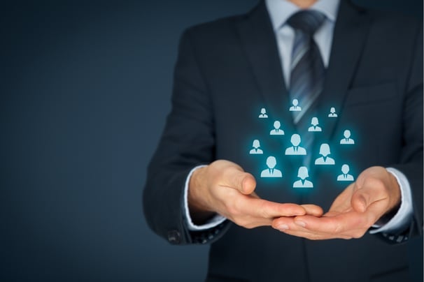 Businessman holding holographic icons of people, symbolizing diverse customers served by Integrix Services