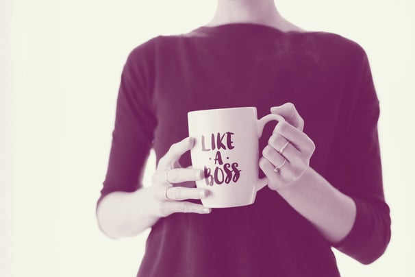 A woman holding a "Like A Boss" mug