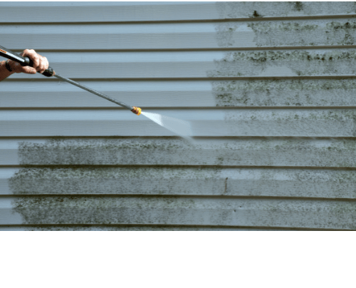 Power washing mold and dirt off vinyl house siding during a residential exterior cleaning service