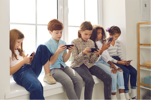 Adolescents all looking at devices
