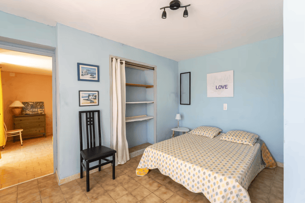 a bedroom with a bed and a chair