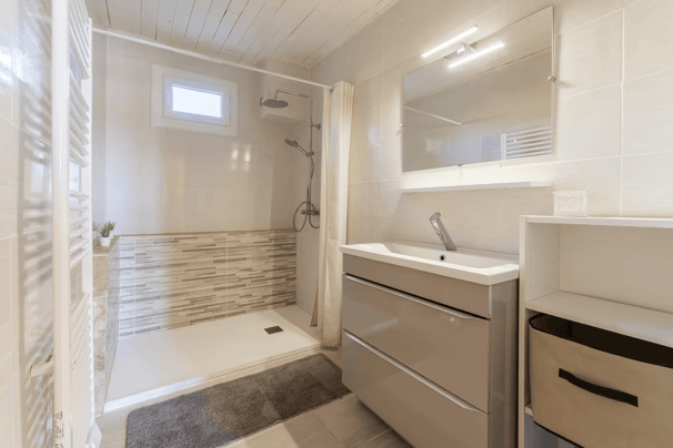 a bathroom with a shower and a sink