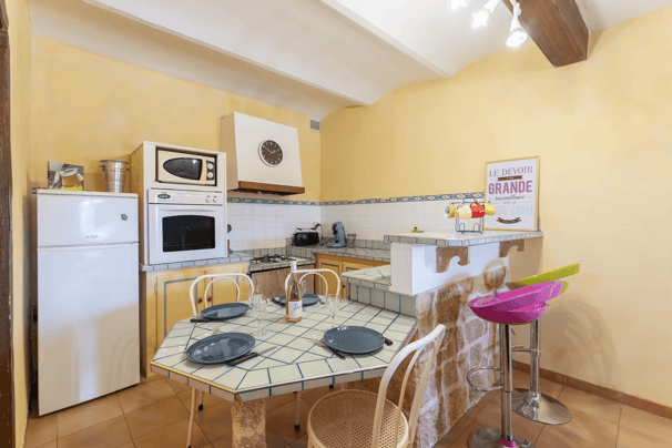 a kitchen with a table and chairs and a refrigerator