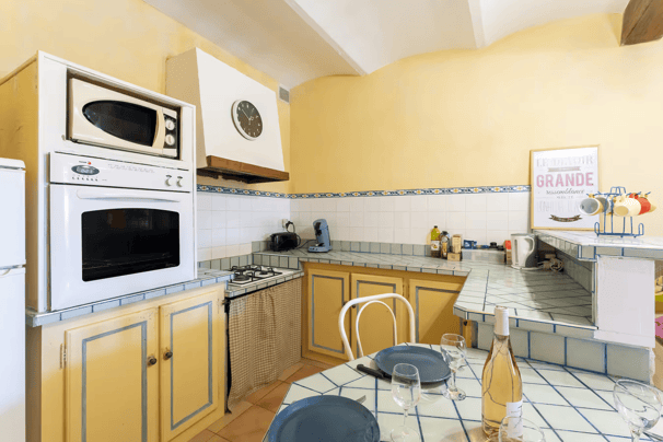 a kitchen with a table and chairs and a microwave