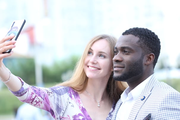 a man and woman taking a selfie to create 3D cartoon characters