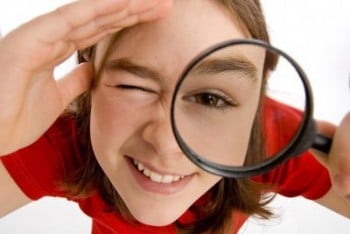 a girl holding a magnifying magnifying magnifying a magni