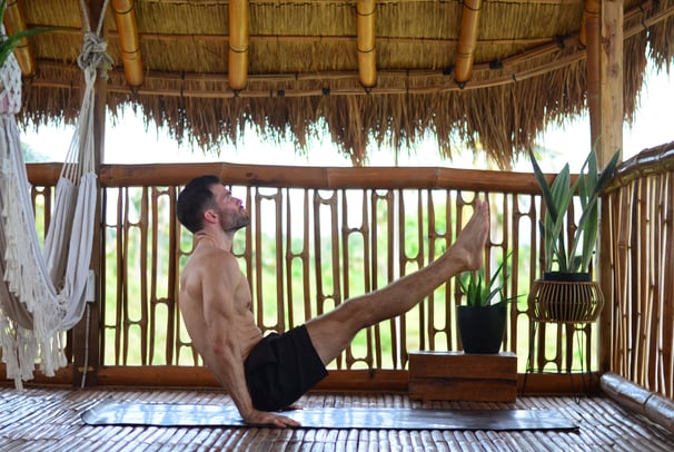 V-Sit on Yoga Mat in Nipa Hut