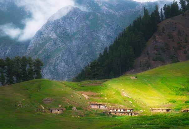 a mountain scene with a train passing by a mountain