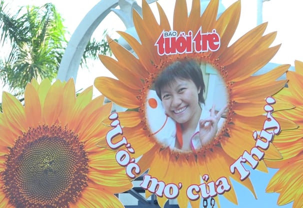 a sign with a picture of a young girl in a sunflower