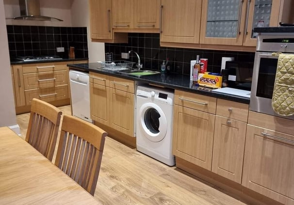The kitchen at Gourock Seaview Holiday Let with a dining table and washing machine