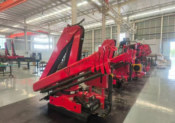 SQZ84B.3 truck-mounted hydraulic knuckle boom loader crane, workshop-ready for diverse lifting tasks.
