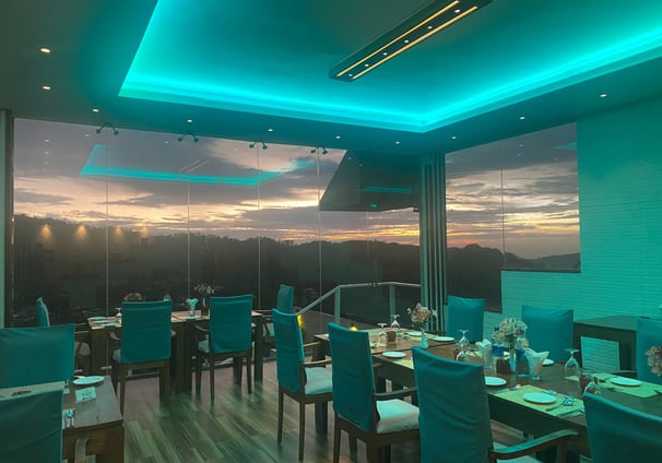 a dining room with a view of the sunset