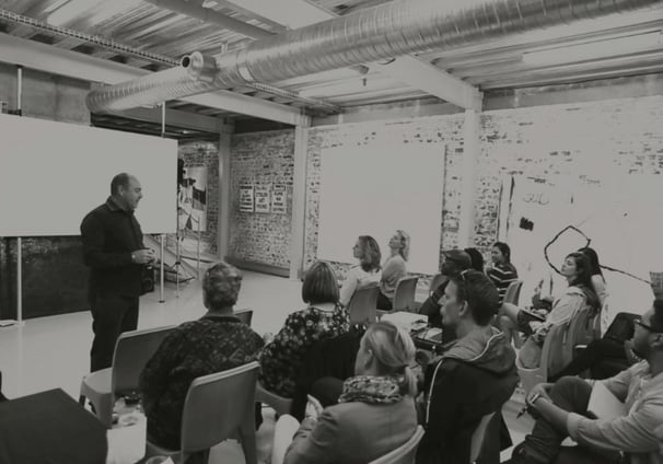 Martin Osner teaching a group of students in a workshop at the Photography School and Art Academy.