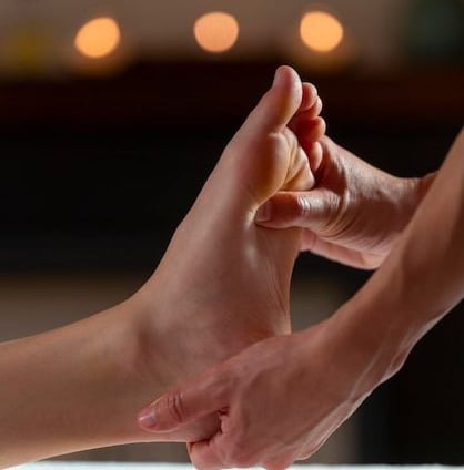a person's foot and foot in a massage room