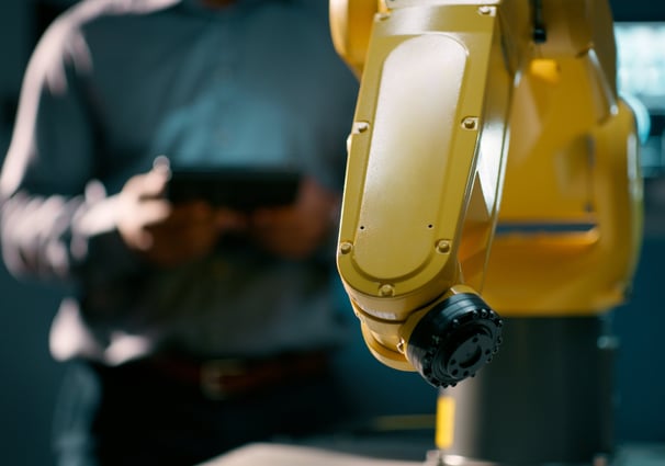 man servicing a fanuc robot