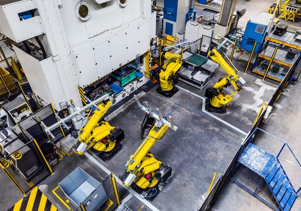 a factory with fanuc robots tending a press brake machine