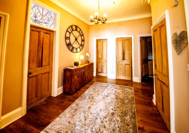 The Hallway at Gourock Seaview Holiday Let with a view with side table and large clock on the wall